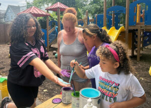 Kids painting their hands on a playground