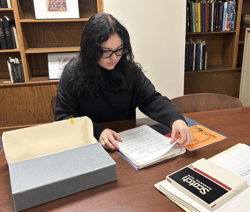 Student assistant Cassidy Kuhar works with the Kathy Feltey papers, which were donated to the Akron LGBTQ+ Archive Initiative.
