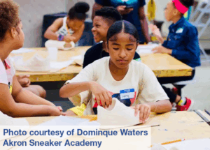 A girl decorating a sneaker