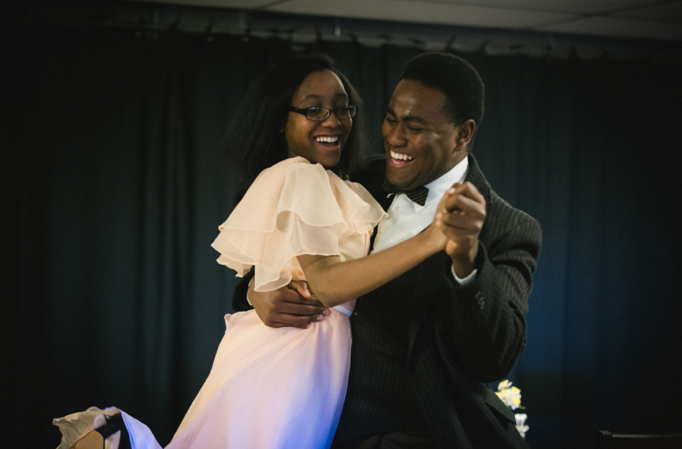 Two actors dancing and smiling