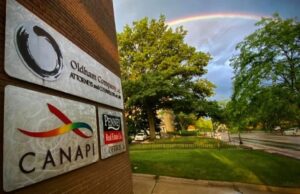 The CANAPI building with a rainbow in the background