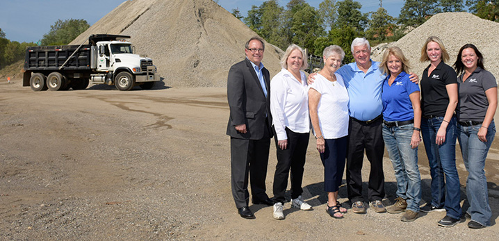 Family stands in front of construction site