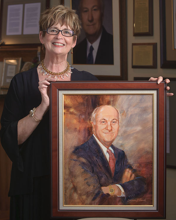 Eileen Burg holds portrait of Pete Burg