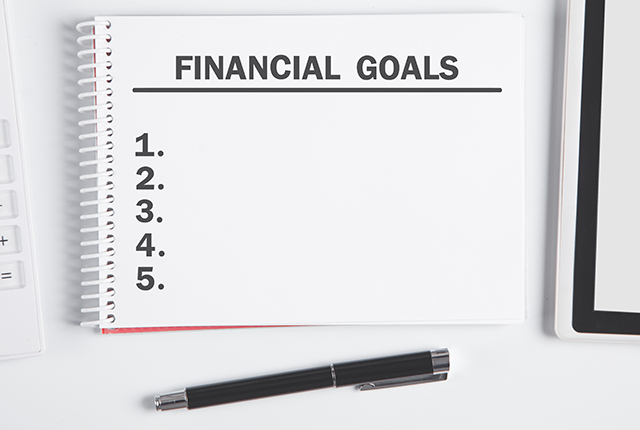 A blank notepad with the heading 'FINANCIAL GOALS' and a list of items 1-5.