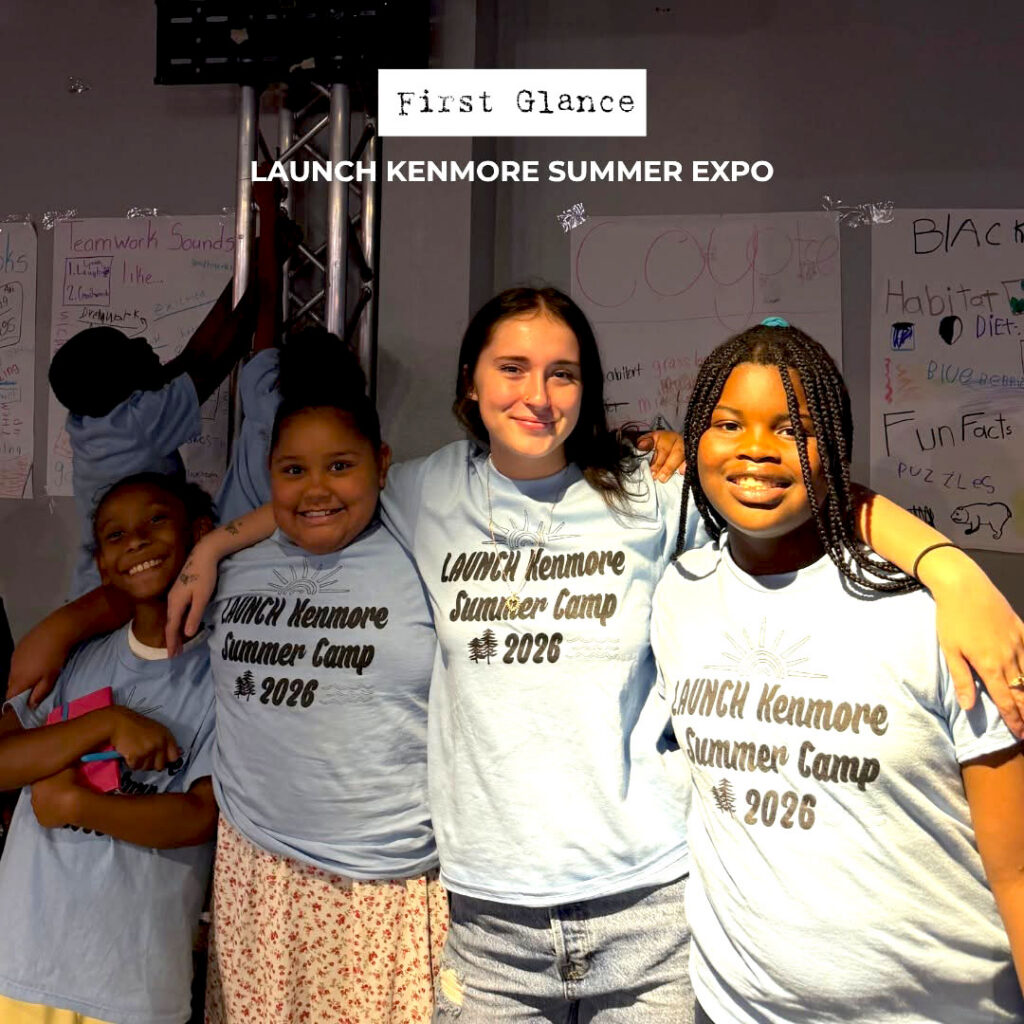 A youth mentor stands with three other girls at an event.