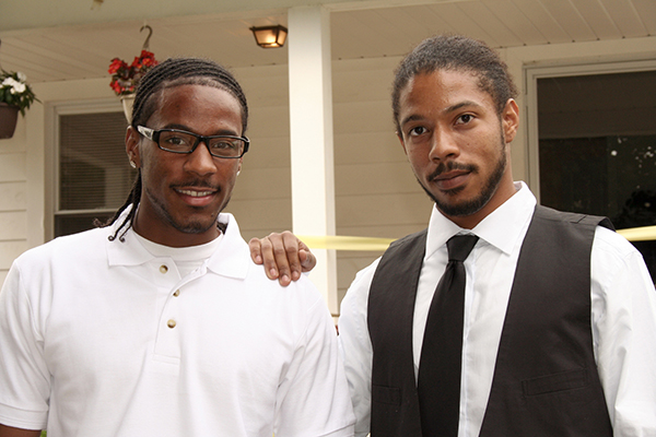 Two men standing next to each other smiling