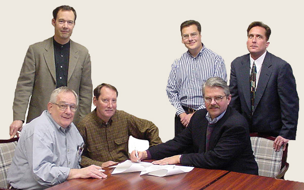Group of men signing document