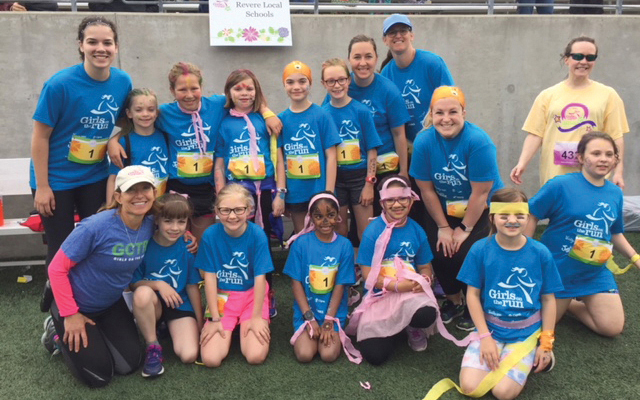 Young female runners pose for team photo