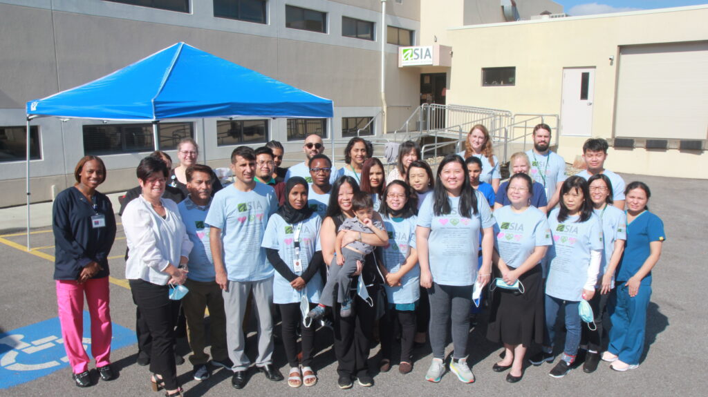 Group of ASIA Inc. staff members pose for photo