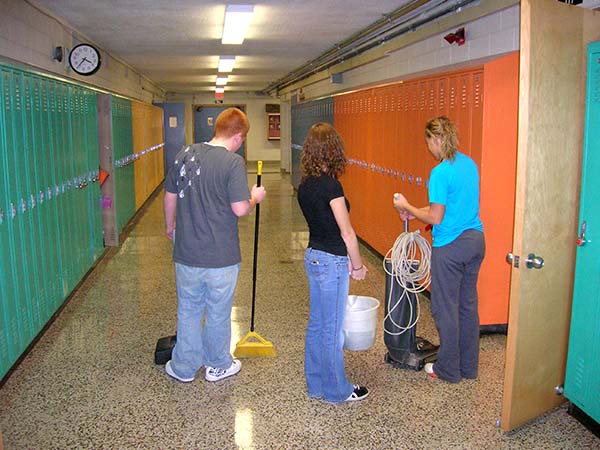 Teens cleaning school floors