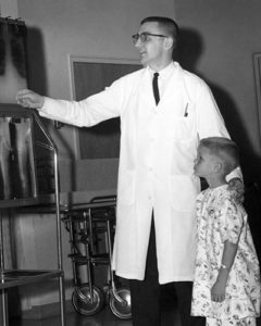 Image of Dr. Ken Swanson with a child