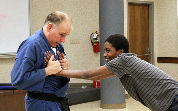 Teen boy practices skills with instructor