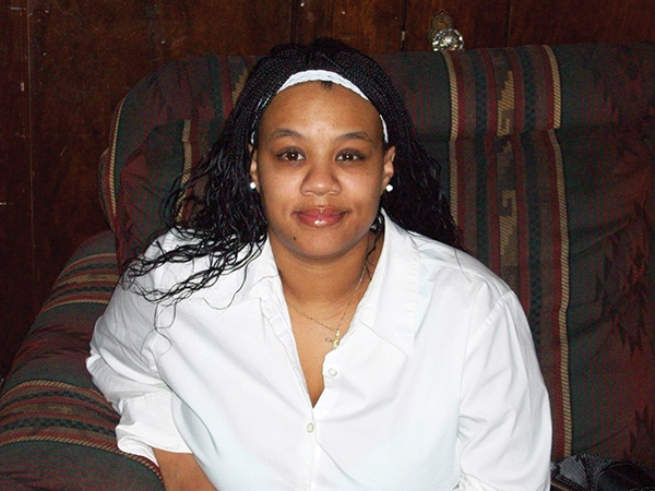 Woman seated on couch smiling