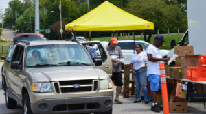 Good Samaritan Hunger Center volunteers load food into a car in the North Hill community.