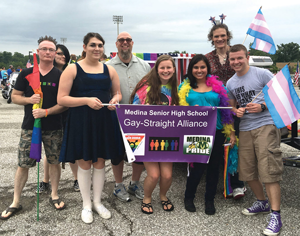 Group of students hold GSA parade sign
