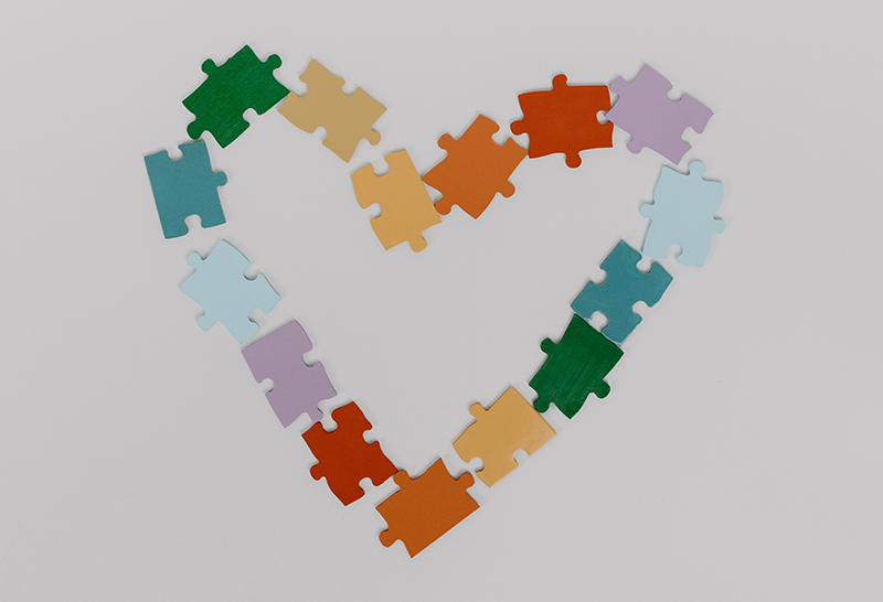 Colorful puzzle pieces in a heart shape
