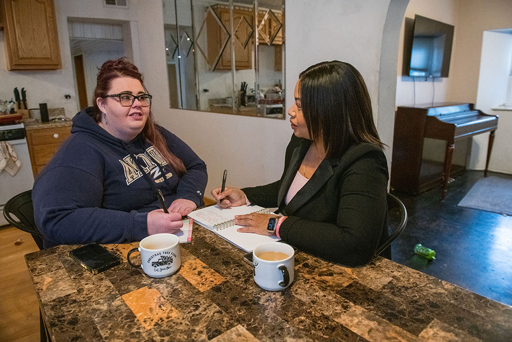 Two women sitting at a table talking