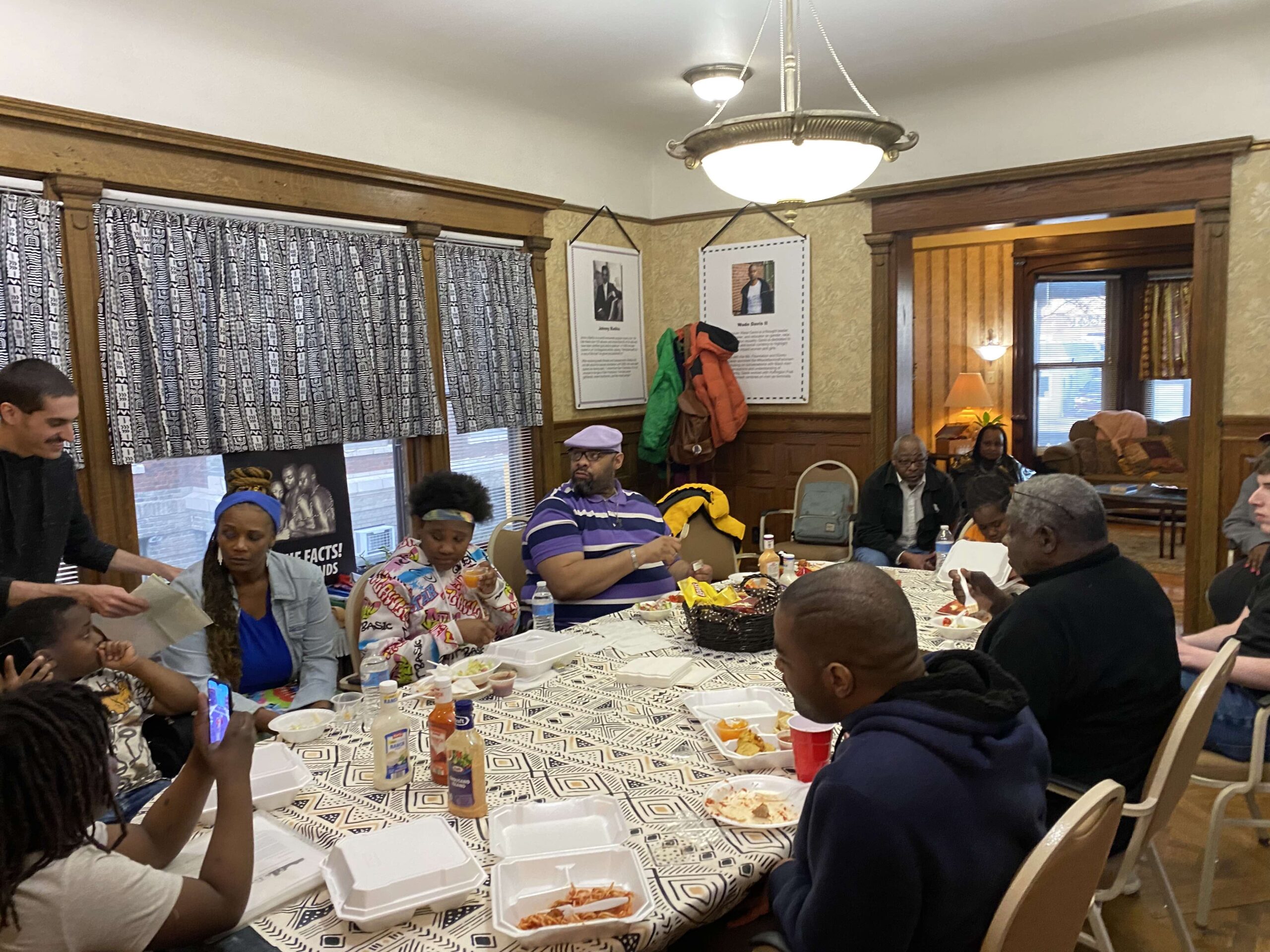 Group of people meeting around a table for a support group