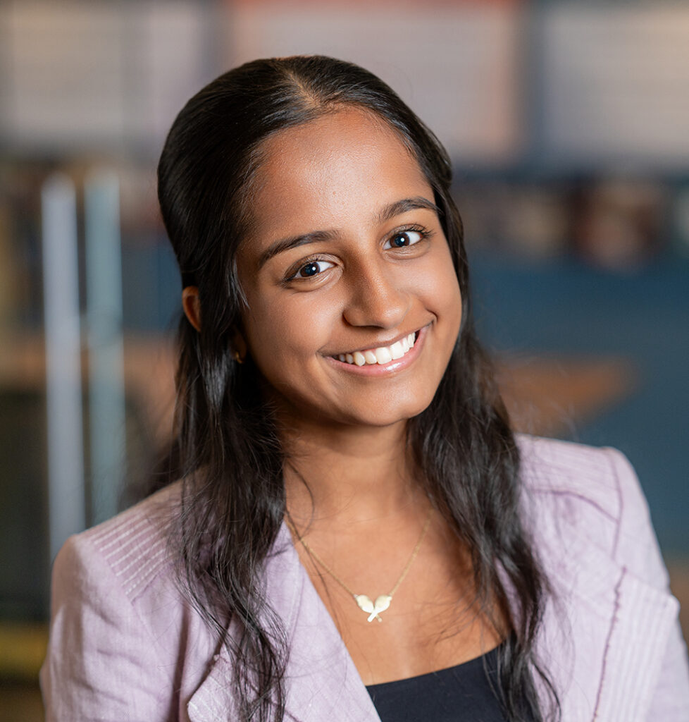 Headshot of Sia Mahesh smiling