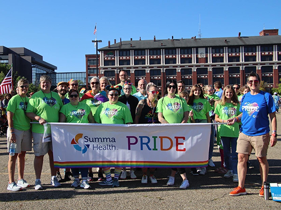 Summa Health pride clinic supporters hold a banner during a parade