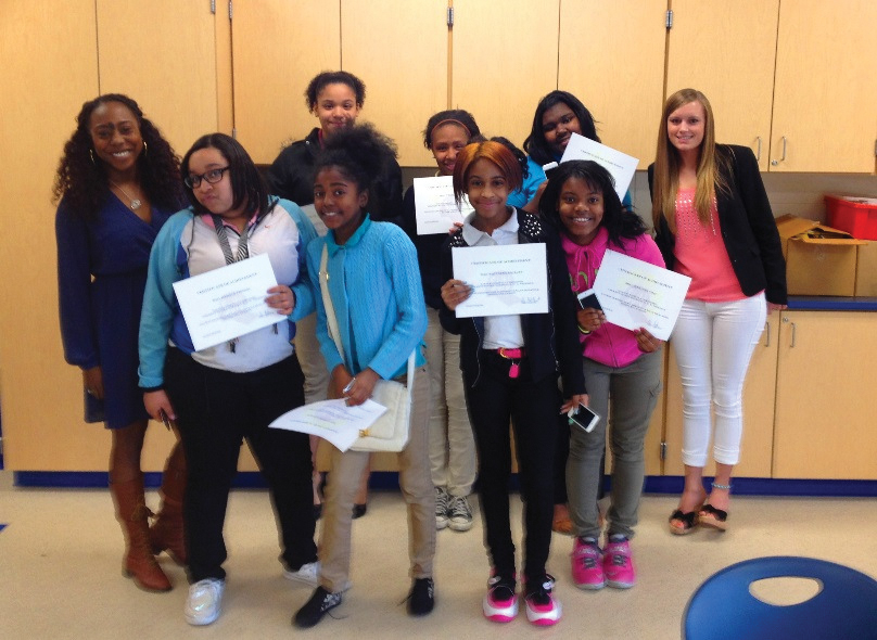 Group of teen girls smile and hold certificates