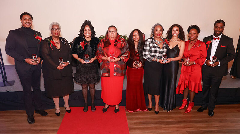 A group of award recipients pose for a photo