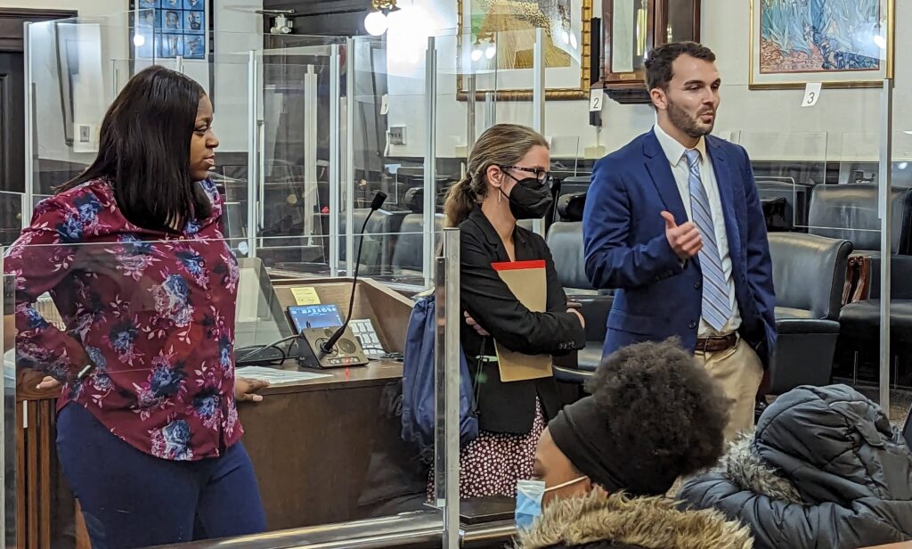 Attorneys stand in a courtroom