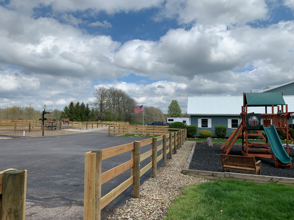 Fencing runs along a barn at Victory Gallop