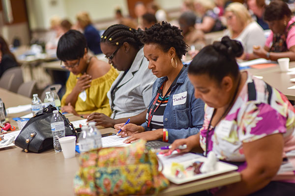 Women writing while seated