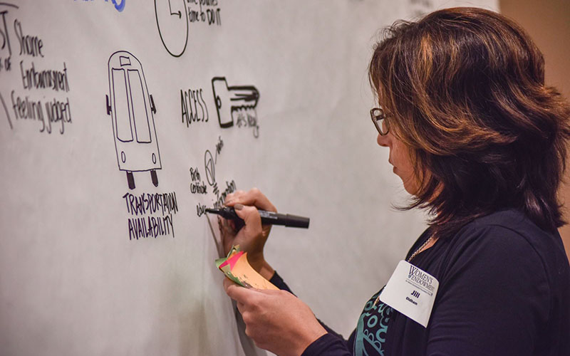 Woman sketching on wall mural