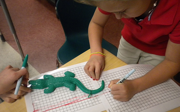 Student measures polymer alligator