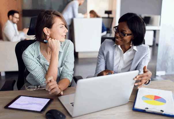 Advisor meets with client looking at a laptop and colorful charts