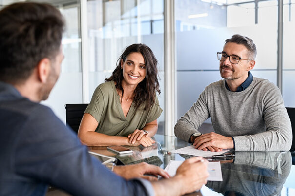 Smiling mature couple meeting with advisor