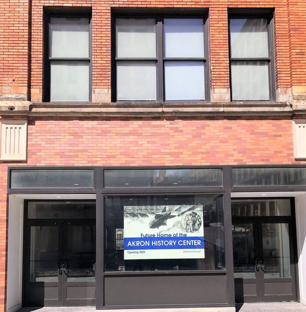 A sign on a building in Akron reads: Future Home of the Akron History Center, Opening 2023