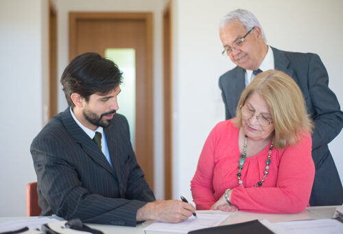 Couple signing paperwork