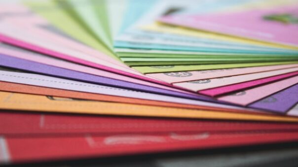 Stacks of multicolored paper, representing direct mail campaigns.