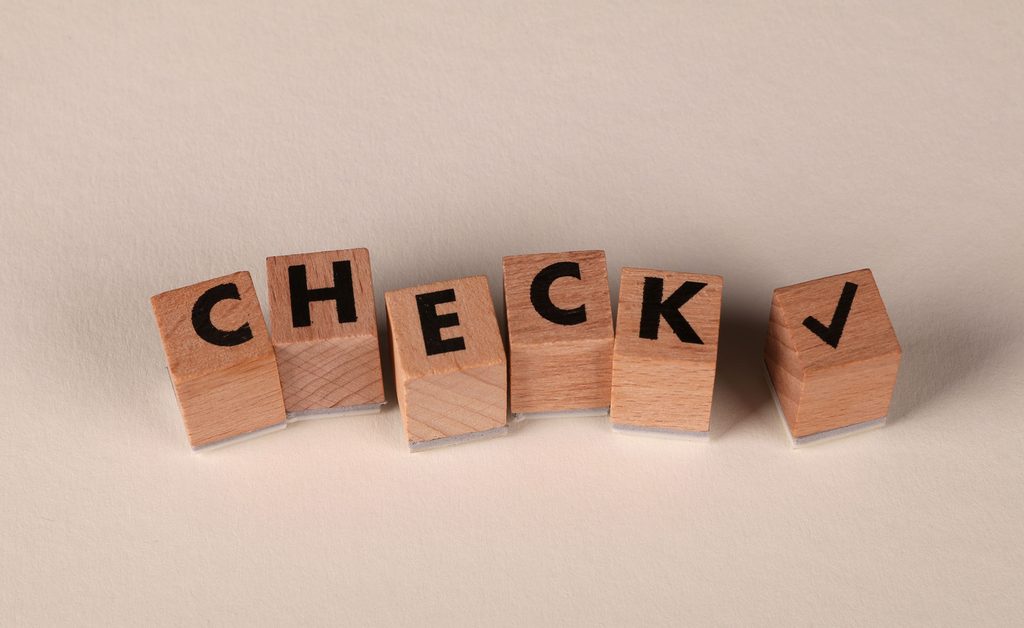 wood block spell out the word "check"