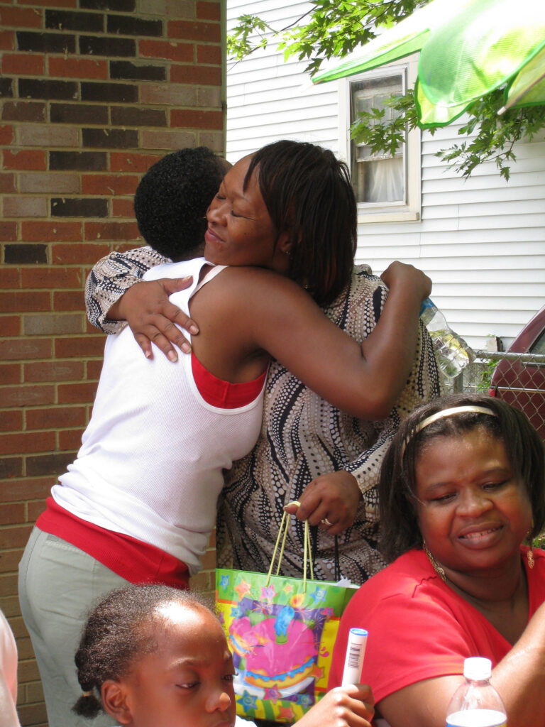 Freedom House Founder Eva Hartwell hugs a program participant at a celebration for the nonprofit.