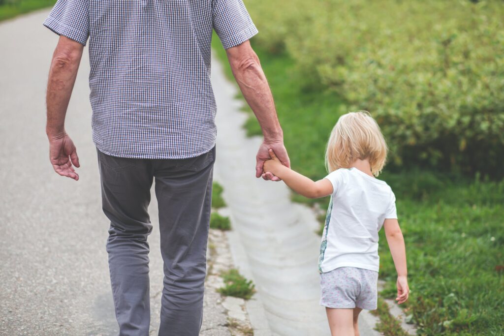 Grandpa holding child's hand