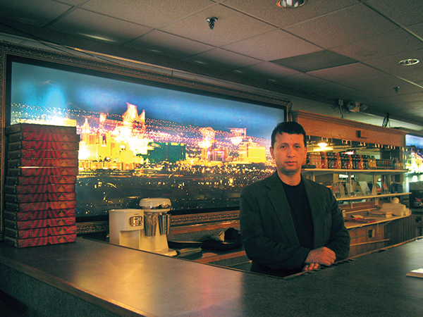 Man standing behind restaurant counter