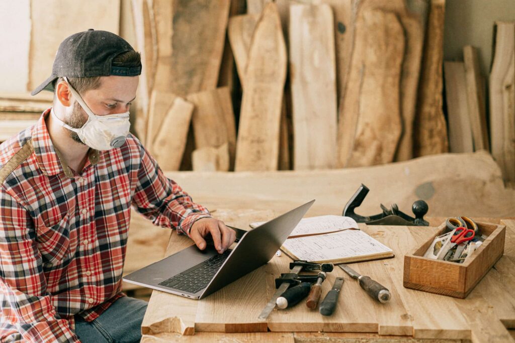 Construction worker looking at a laptop