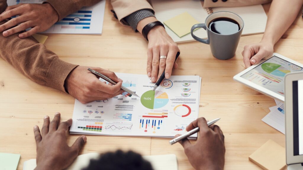 Hands pointing to a financial dashboard