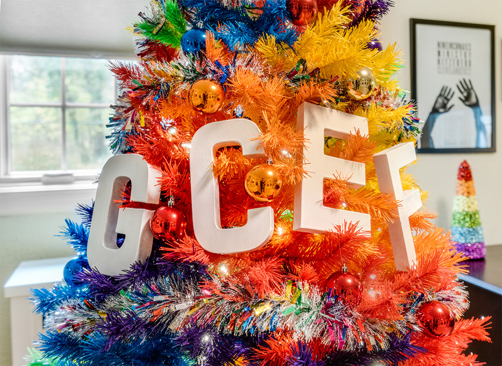 A rainbow Christmas tree with the letters GCEF