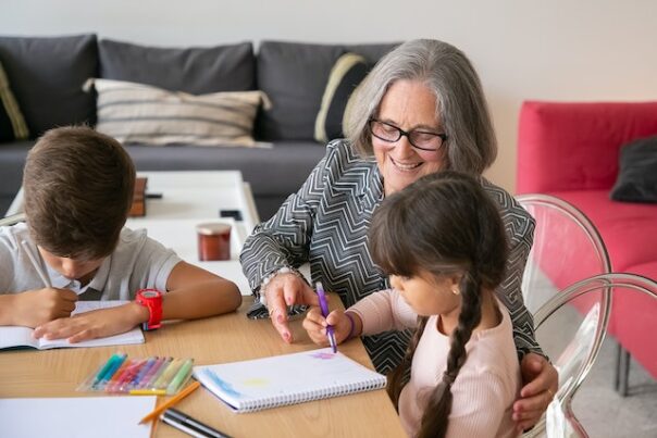 Woman helping grandchildren with art project