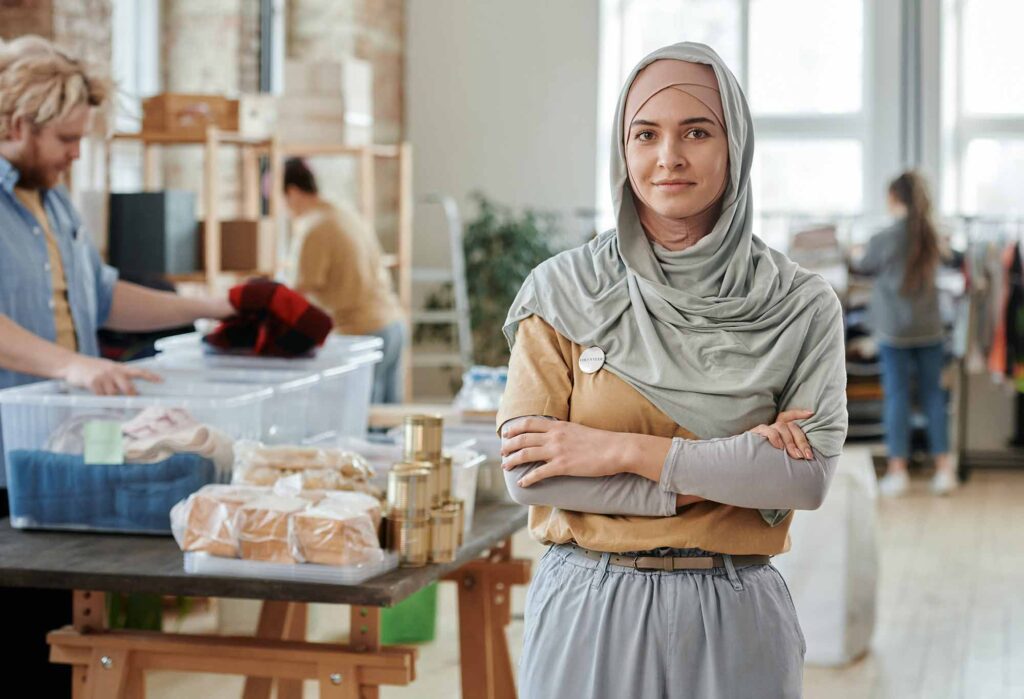 Woman wearing a hijab volunteering in a food pantry